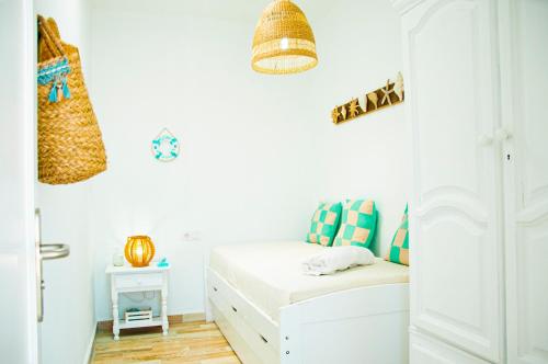 a small bedroom with a bed and a table at Turquesa Beach&Pool Apartaments in Playa Honda