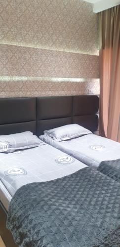 two beds sitting next to each other in a bedroom at Nova city center apartments in Tbilisi City