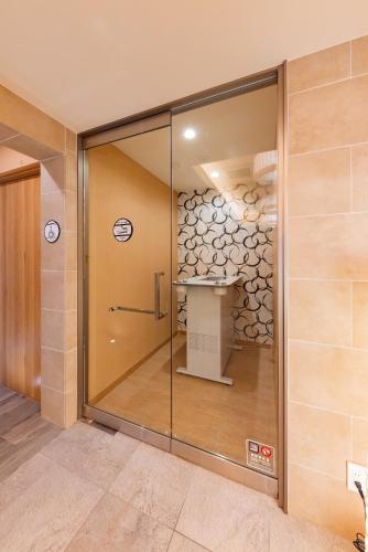 a glass door in a room with a table at GOLD STAY Nagoya Sakae ゴールドステイ名古屋栄 in Nagoya