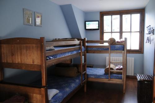 a room with three bunk beds and a window at Borda Felices in Broto