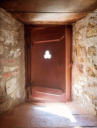 a door in a brick wall with a light in it at Agriturismo Castello Di Belforte in Todi