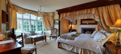 a bedroom with a large bed and a living room at Glyn Isa Country House B&B and self catering Lodge in Conwy