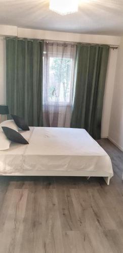 Schlafzimmer mit einem großen weißen Bett vor einem Fenster in der Unterkunft Apartman MERI in Rogoznica