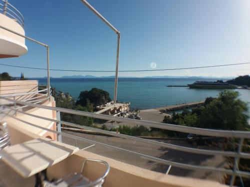 a balcony with a view of the water at Harbour View - Oceanis Apartments in Poros