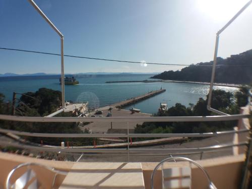 a view of a body of water with a pier at Harbour View - Oceanis Apartments in Poros