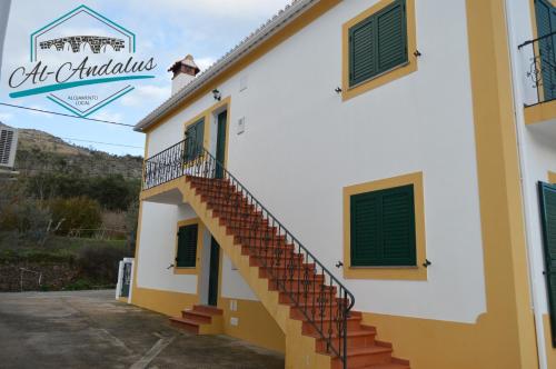 a building with stairs on the side of it at Al-Andalus Alojamentos in Marvão