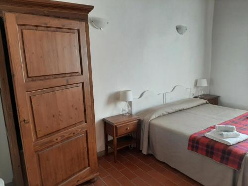 a bedroom with a bed and a dresser next to a bed at Agriturismo Il Frantoio Di Colle Alberto in Montale