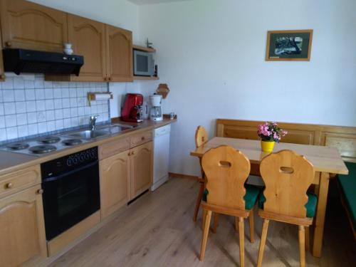 a kitchen with a table and chairs and a sink at Bergruhe in Sankt Ruprecht ob Murau