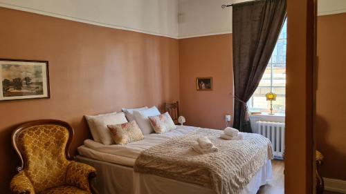 a bedroom with a bed with two towels on it at Leopold Boutique Hotel in Östersund