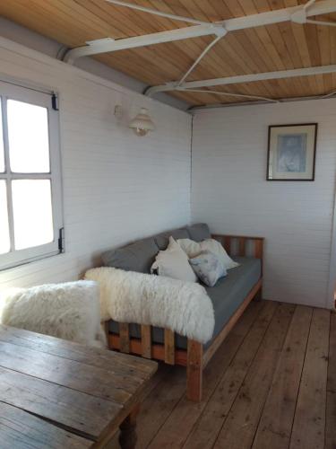 ein Bett in einem Zimmer mit Holzboden in der Unterkunft Vittorio, en Llohue in Villa Ventana
