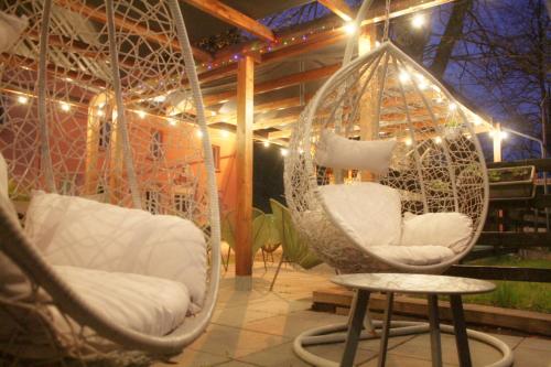 a room with two swinging chairs and a table at Chabanettes Hotel & Spa in Auzelles