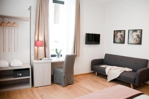 a living room with a couch and a desk at Giuturna Boutique Hotel in Rome