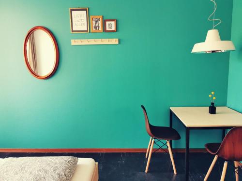 a room with a mirror and a table and a chair at Backpackers Luzern in Luzern