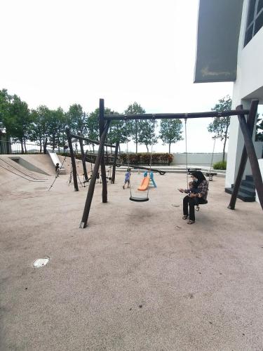 a group of children playing in a playground at THE FAMILY HOMESTAY@UNIV360 PLACE,SERDANG in Seri Kembangan