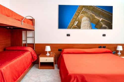 a bedroom with two beds and a tower at Hotel Almas in Capaccio-Paestum