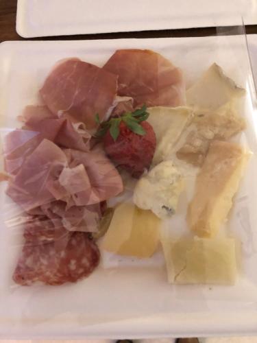 a plate of food with meat and cheese on it at CA' DEL RE SCARTOZZ in Gavirate