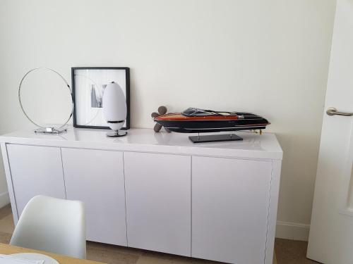 a white dresser with a mirror on top of it at Appartement Centre ville carré d'Or in Monte Carlo