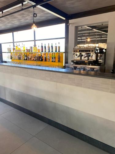 a bar in a restaurant with a lot of drinks at Hotel Almas in Capaccio-Paestum