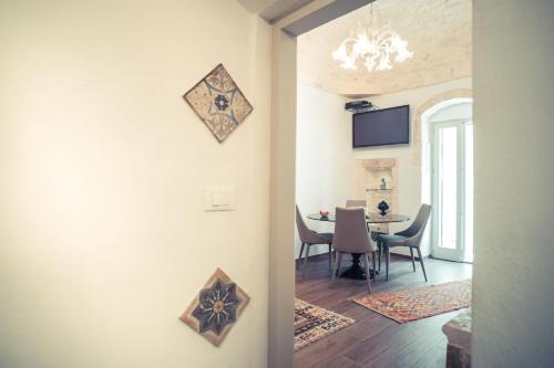 a room with a table and a dining room at 800s Home Luxury Rooms in Ostuni