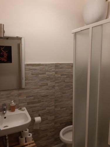 a bathroom with a toilet and a sink and a shower at Villa Dietro la Luna in Torre del Greco