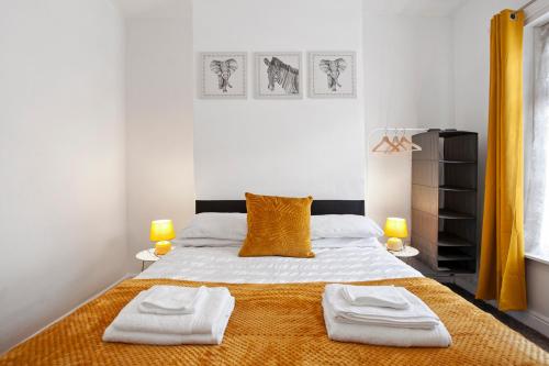 a bedroom with a bed with two towels on it at Staywhenever LS- 4 Bedroom House, King Size Beds, Sleeps 9 in Stoke on Trent