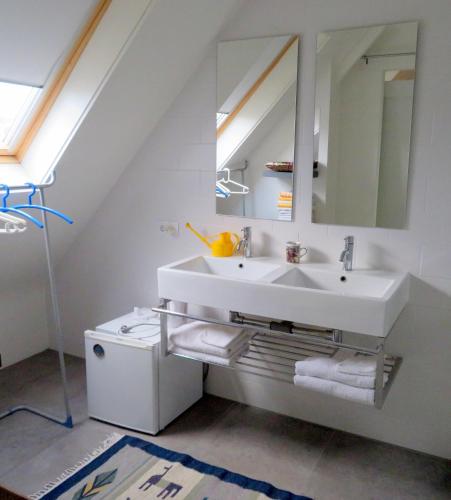 a bathroom with a sink and a mirror at Jacky's place in Helmond