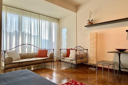 sala de estar con sofá y ventana en COCO' HOUSE: PRESTIGIOSO APPARTAMENTO IN CENTRO en Turín