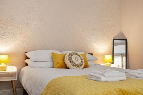 a bedroom with a bed with towels on it at Staywhenever NWT- 4 Bedroom House, King Size Beds, Sleeps 9 in Stoke on Trent