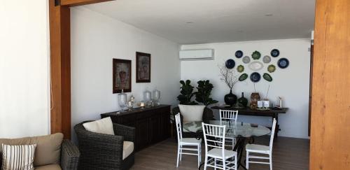 a dining room with a glass table and chairs at Olívale - Turismo Rural in Campo Maior