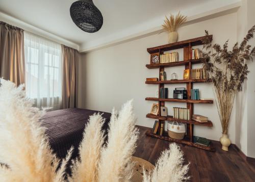 a bedroom with a book shelf and a bed at Rezidence Liepas in Liepāja