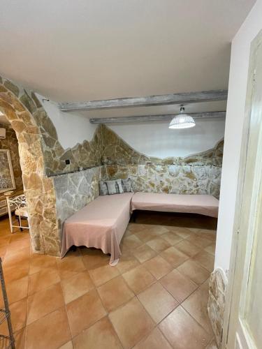 a living room with a couch in a stone wall at Villa Casa Vacanze Fiore in Gallipoli