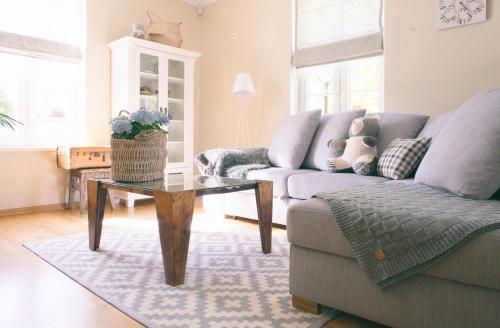 a living room with a couch and a coffee table at Linnuse Apartement in Haapsalu