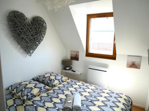 a bedroom with a bed with a heart on the wall at Cabourg Mathilde in Cabourg