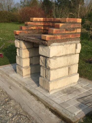 a stack of brick retaining walls on a sidewalk at Maison proche de la mer, Normandie in Surville