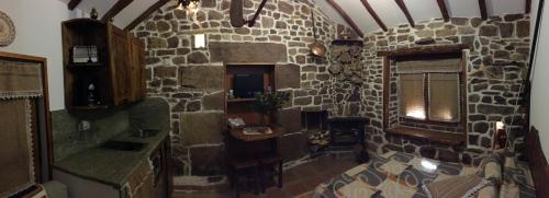 a room with a stone wall and a room with a window at Casa Miguel in Olea