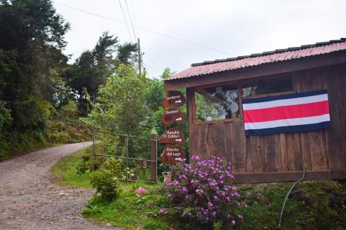 a sign with a flag on a building next to a dirt road at Reserva Natural Cerro Alto in Empalme