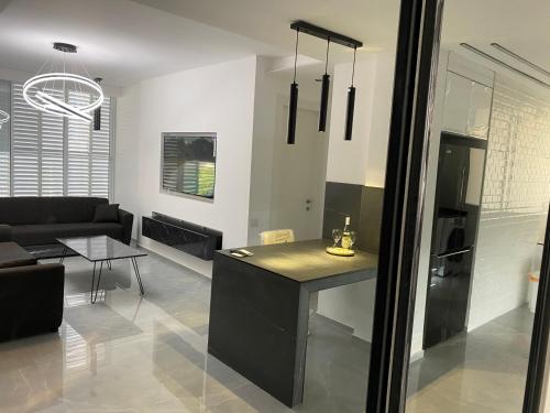 a kitchen and living room with a couch and a table at New! luxus- Best suit 2 minutes fromTel Aviv in Bat Yam