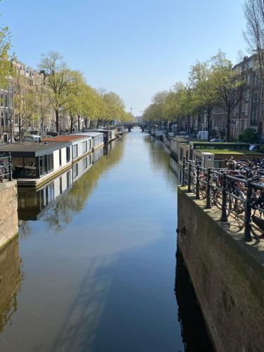 a view of a canal with buildings on the side at Houseboat Sophia in Amsterdam