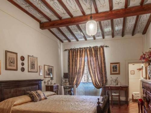サン・カシャーノ・デイ・バーニにあるPalazzo Palesaのベッドルーム(ベッド1台、窓付)