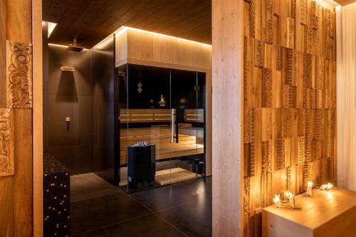 a hallway with a room with a table and a wall with books at Boutique Hotel Sunrose 7 - Gourmet & SPA in Bohinj