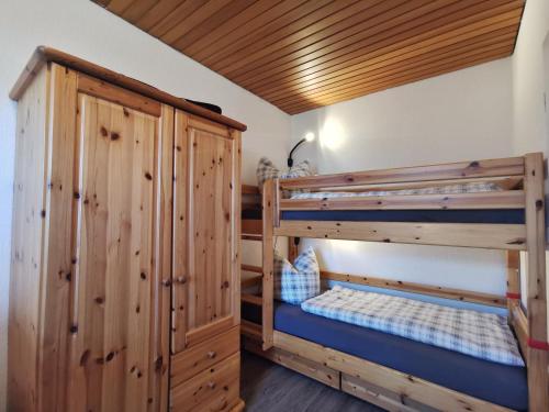 a room with two bunk beds and a cabinet at Nordseegras in Horumersiel