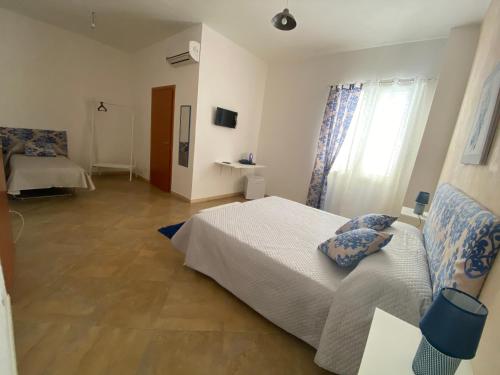 a bedroom with a bed and a window at Il terrazzo dei templi in Marinella di Selinunte