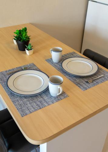 a table with two plates and two cups on it at Villas at Aguada Sea Beach in Aguada