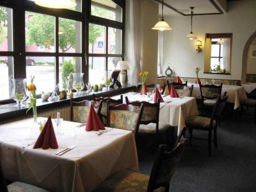 a dining room with tables and chairs with red napkins at Hotel Pfälzer Hof, Zum Schokoladengießer in Rodalben