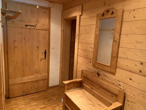 a wooden room with a door and a bench at Apartment La Berciére 6 in Villars-sur-Ollon