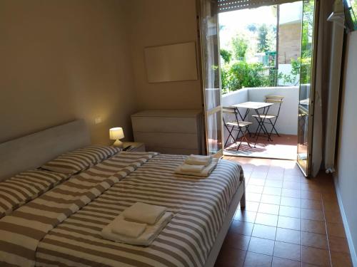 a bedroom with two beds with towels on top of it at Beach House, 300 m dal mare, Marina di Massa in Marina di Massa