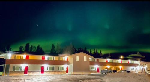 a building with the aurora in the sky at Main Street Hotel in Kenai
