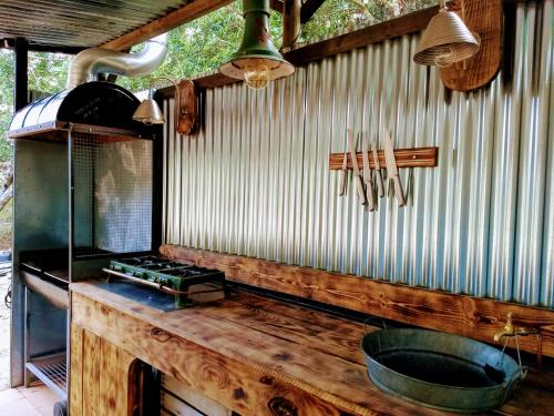 a kitchen with a counter with a sink and a stove at Romantic Safari tent in Tortosa