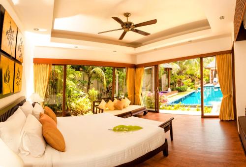 a bedroom with a bed and a pool at Baan Kluay Mai in Hua Thanon Beach