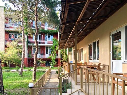 a porch of a house with a deck with a table at Ассоль in Koblevo